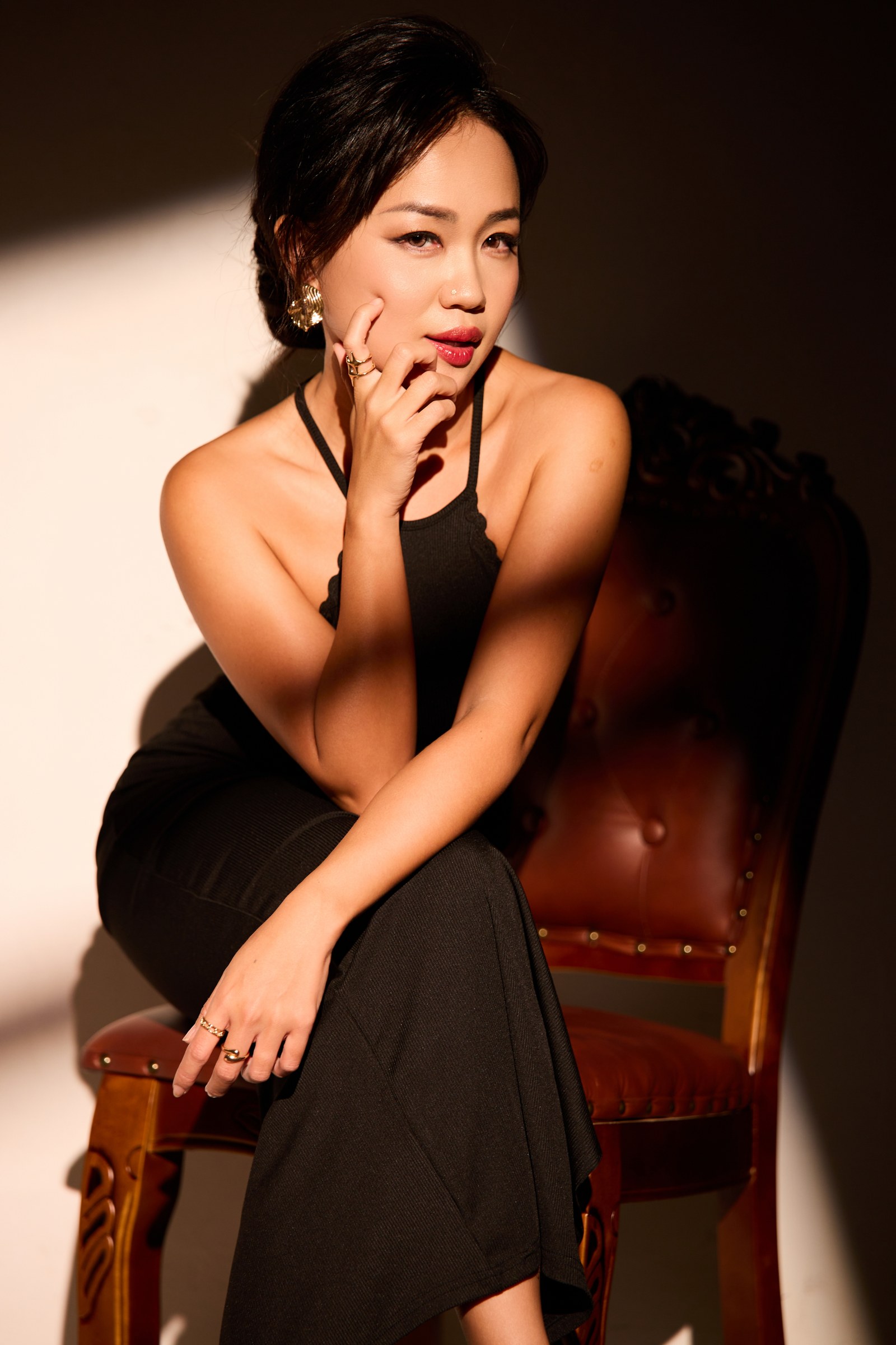 Melodie Yap, seated portrait with cinematic lighting
